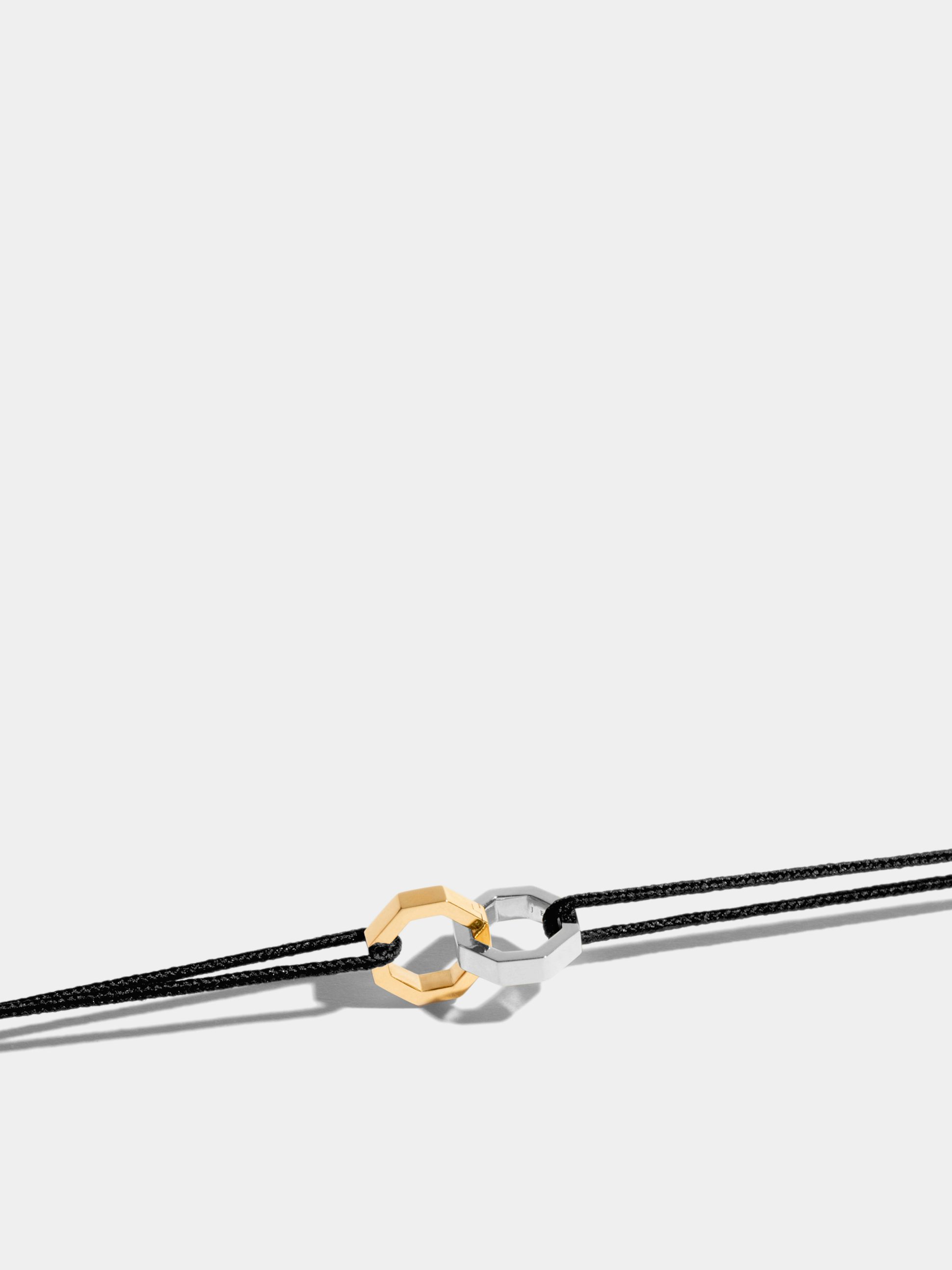 Double Octogone bracelet in 18k Fairmined ethical yellow et white gold, on a black cord. 