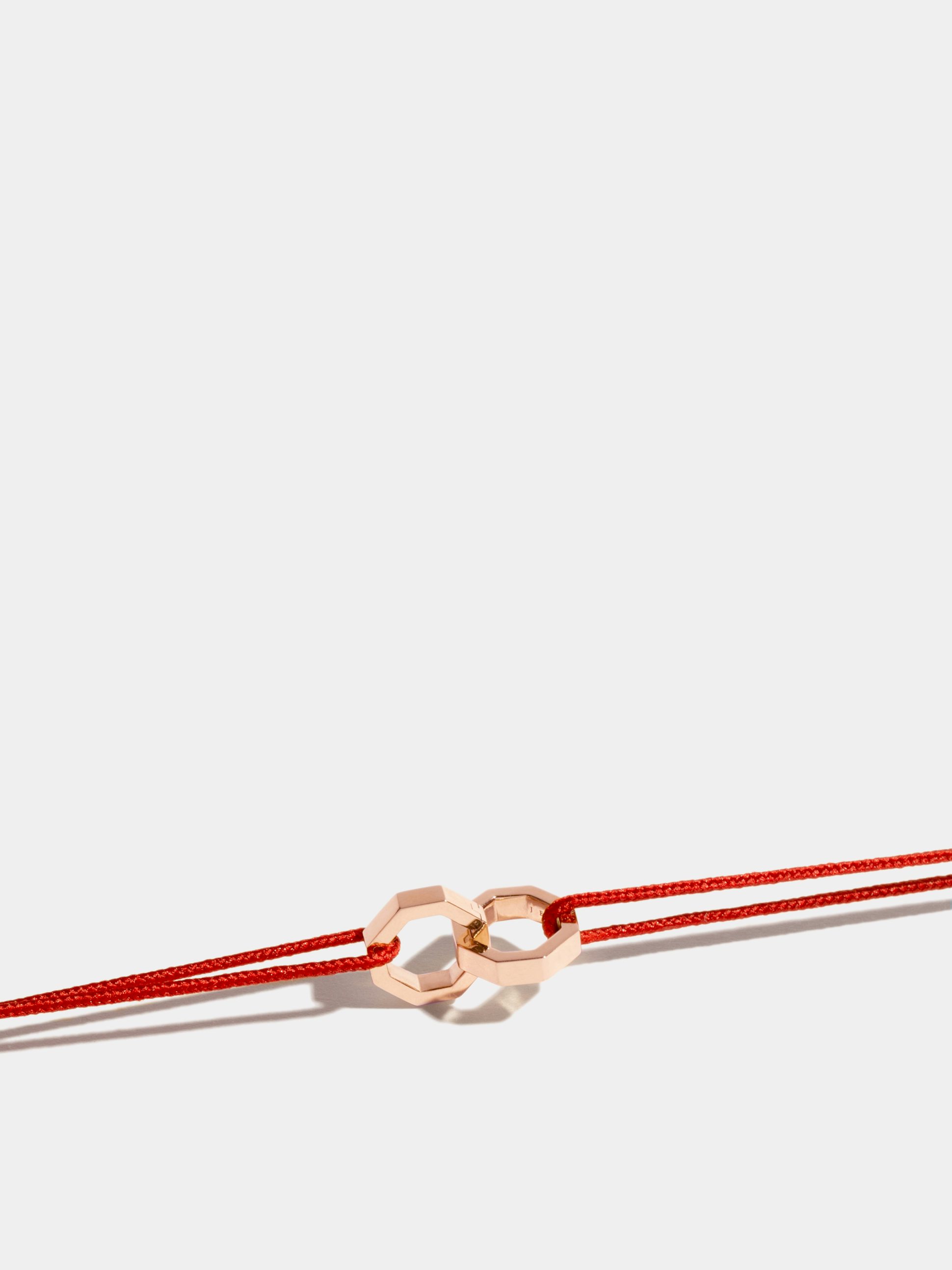 Double Octogone bracelet in 18k Fairmined ethical rose gold, on a red cord. 