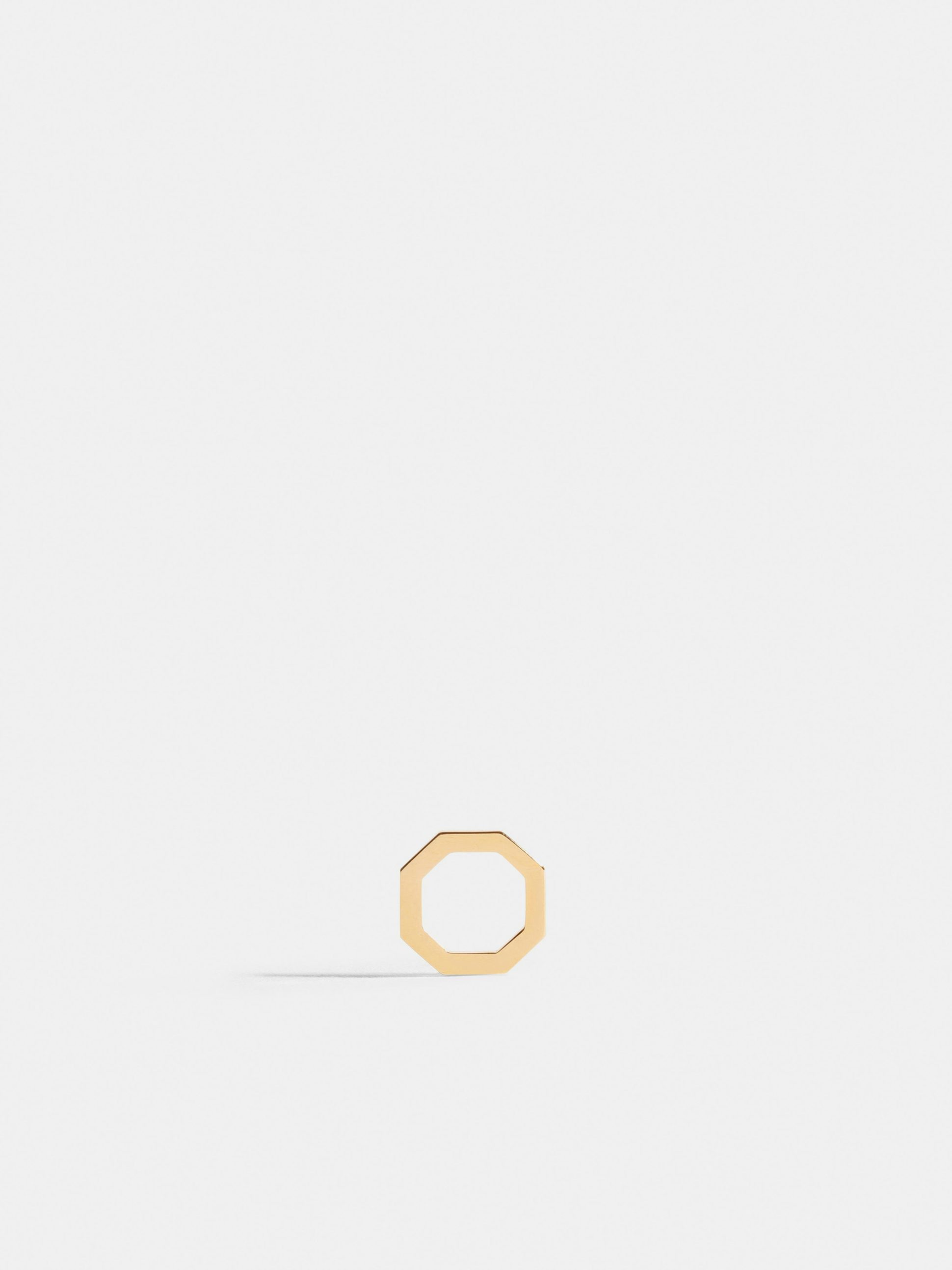 Octogone motif in 18k Fairmined ethical yellow gold, on a bright orange cord. 