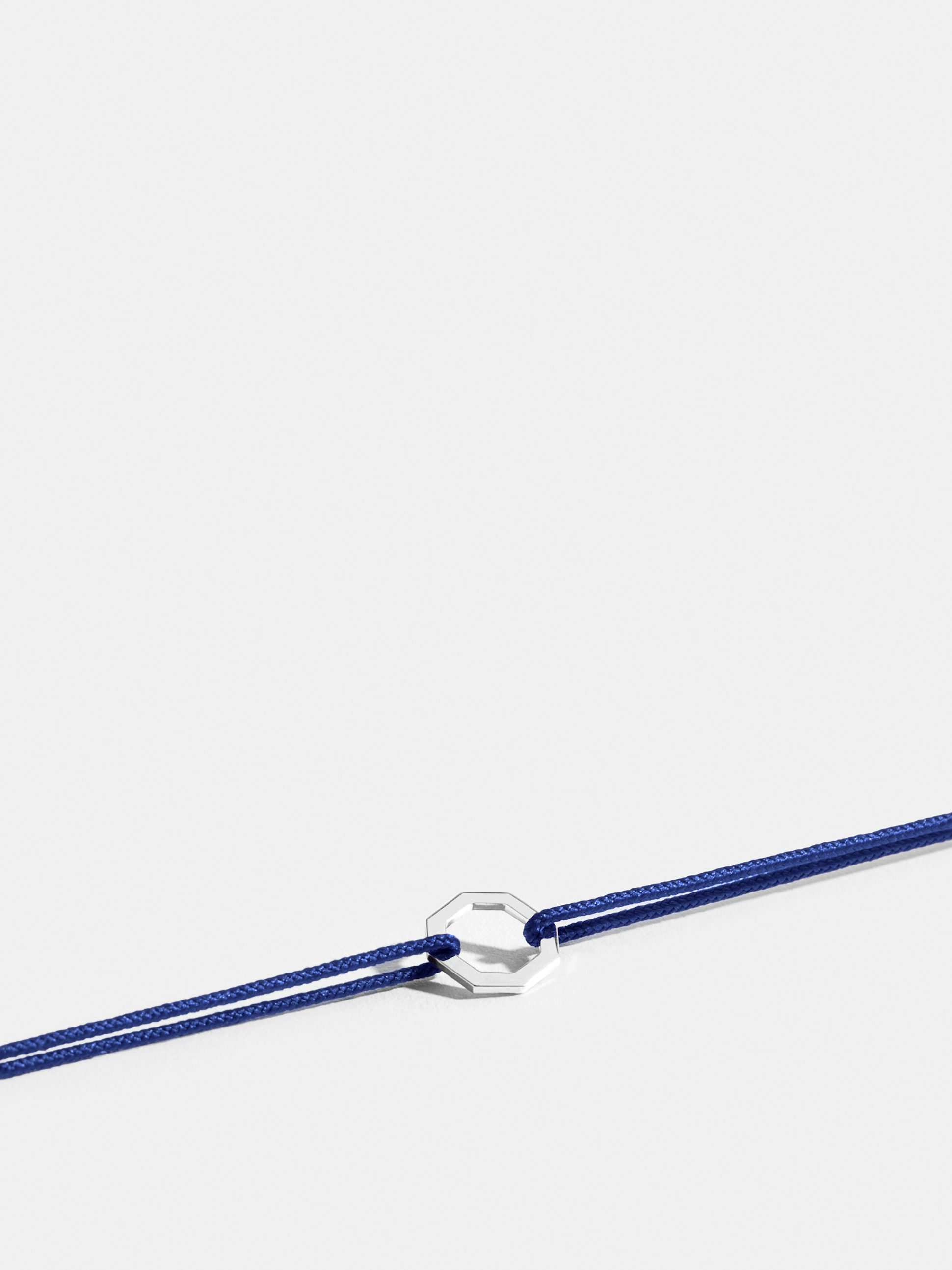 Octogone motif in 18k Fairmined ethical white gold, on a klein blue cord. 