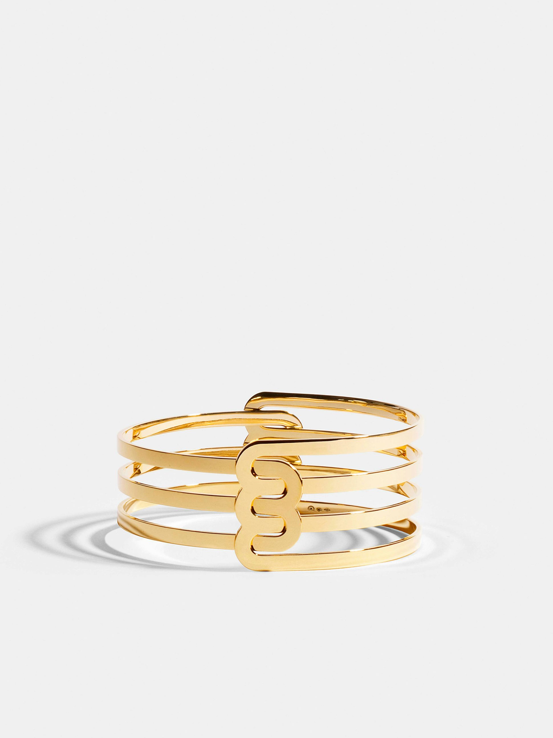 Bracelet Étreintes en Or jaune éthique 18 carats certifié Fairmined composé d'un demi-bracelet double finition poli-brillant et d'un demi-bracelet triple finition poli-brillant.