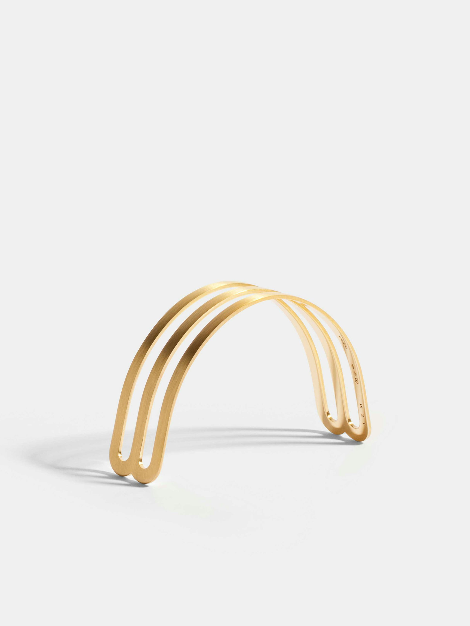Étreintes double half-bracelet in 18k Fairmined ethical yellow gold with a brushed finish.