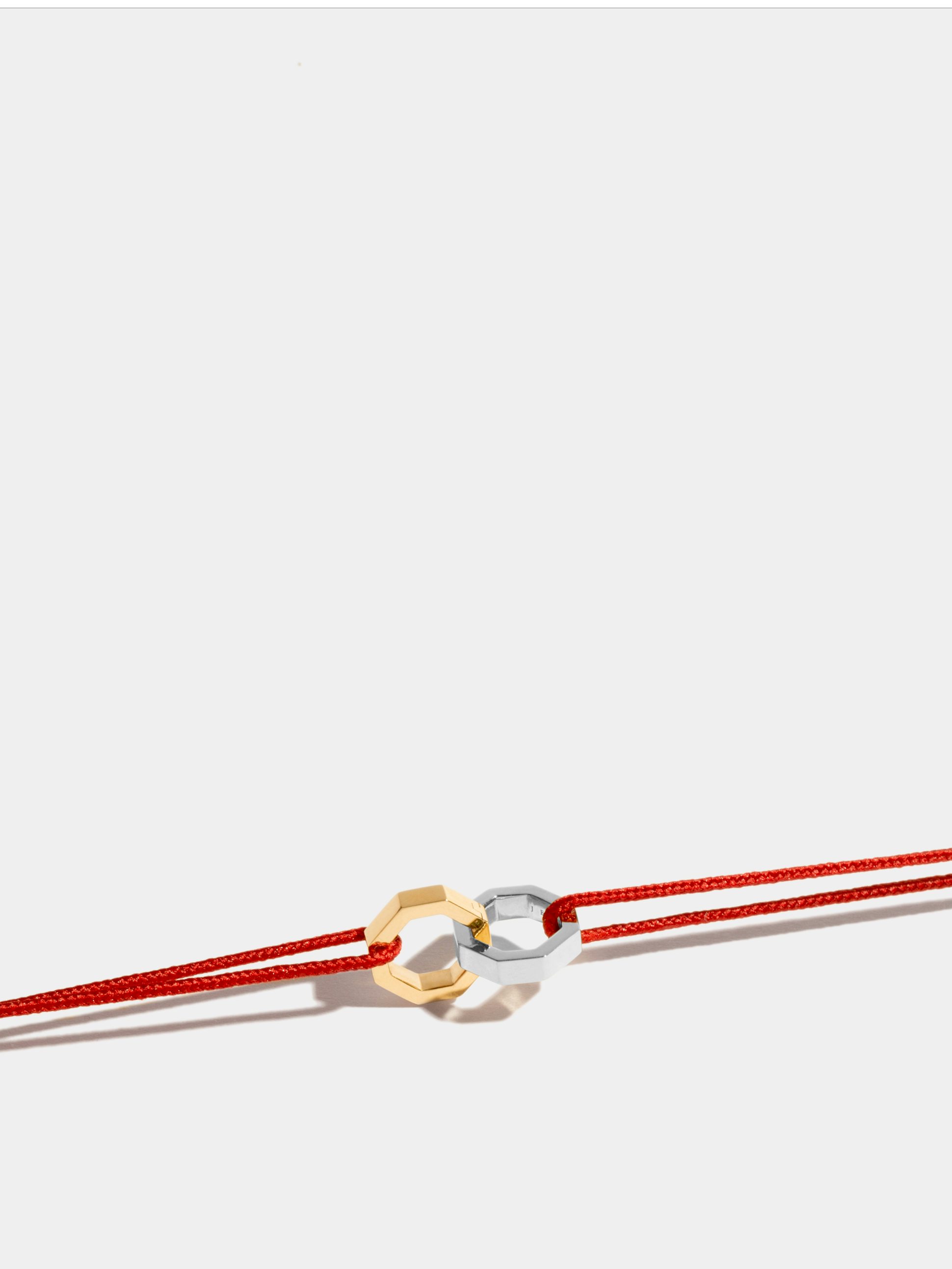 Double Octogone bracelet in 18k Fairmined ethical yellow et white gold, on a red cord.