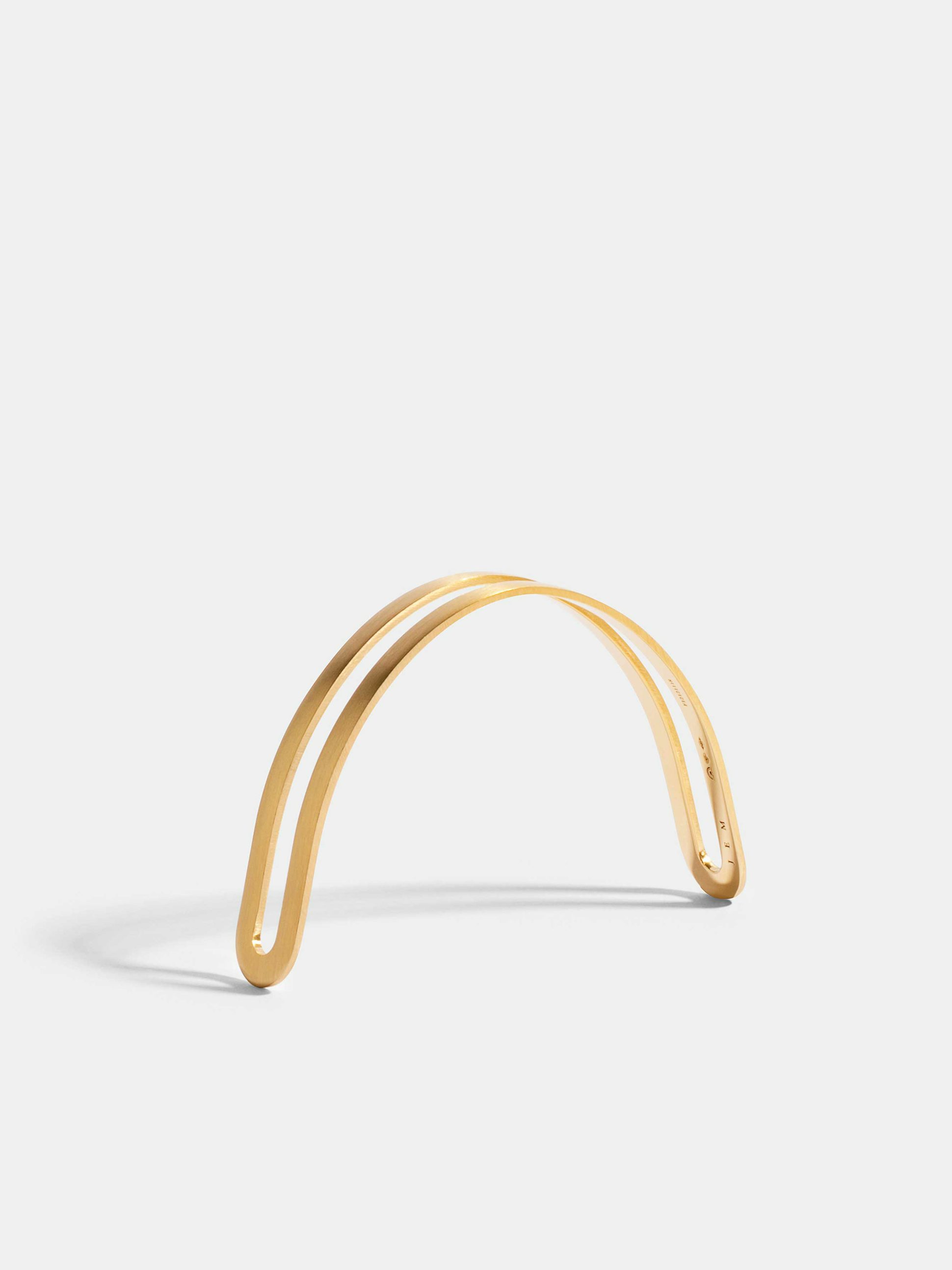 Étreintes simple half-bracelet in 18k Fairmined ethical yellow gold with a brushed finish.