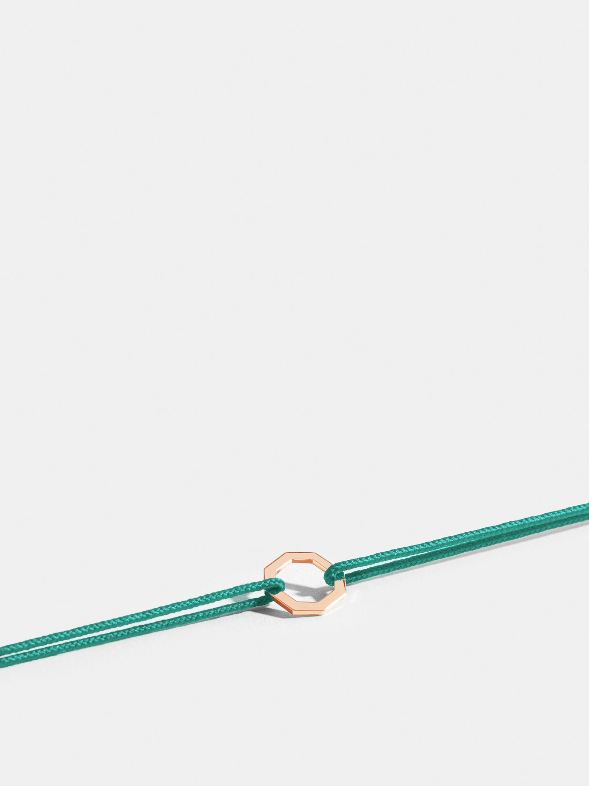 Octogone motif in 18k Fairmined ethical rose gold, on a turquoise blue cord. 