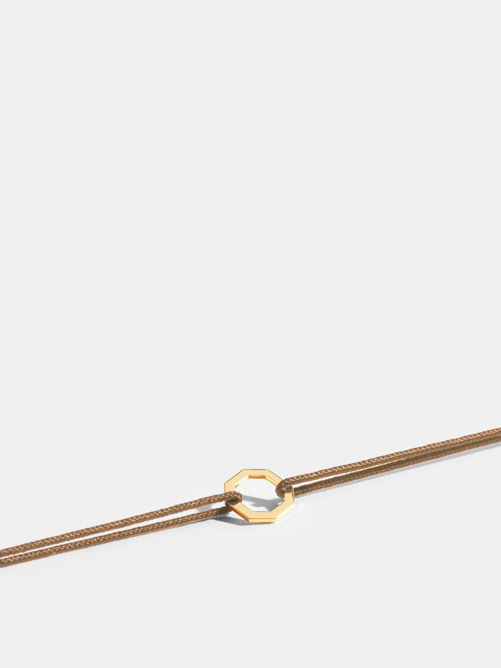 Octogone motif in 18k Fairmined ethical yellow gold, on a honey yellow cord. 