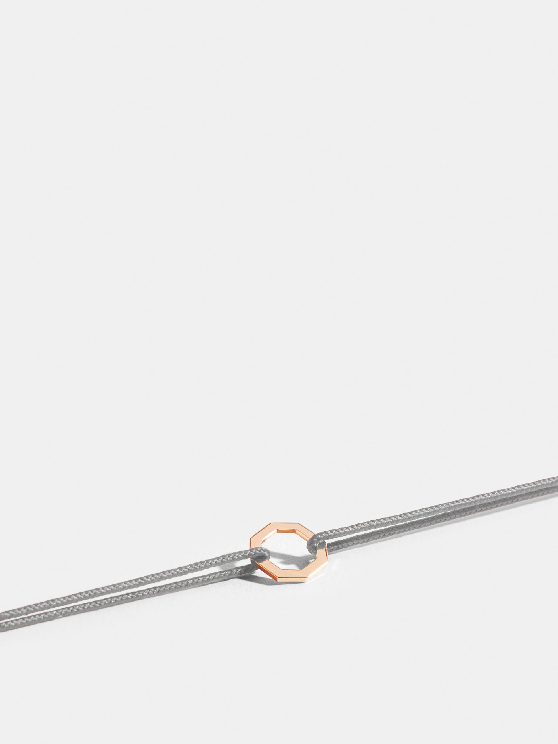 Octogone motif in 18k Fairmined ethical rose gold, on a pearl grey cord. 