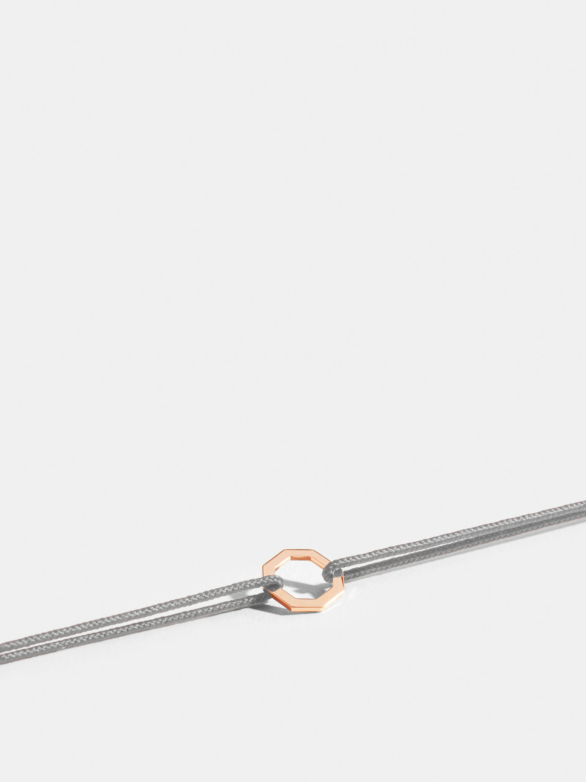 Octogone motif in 18k Fairmined ethical rose gold, on a pearl grey cord.