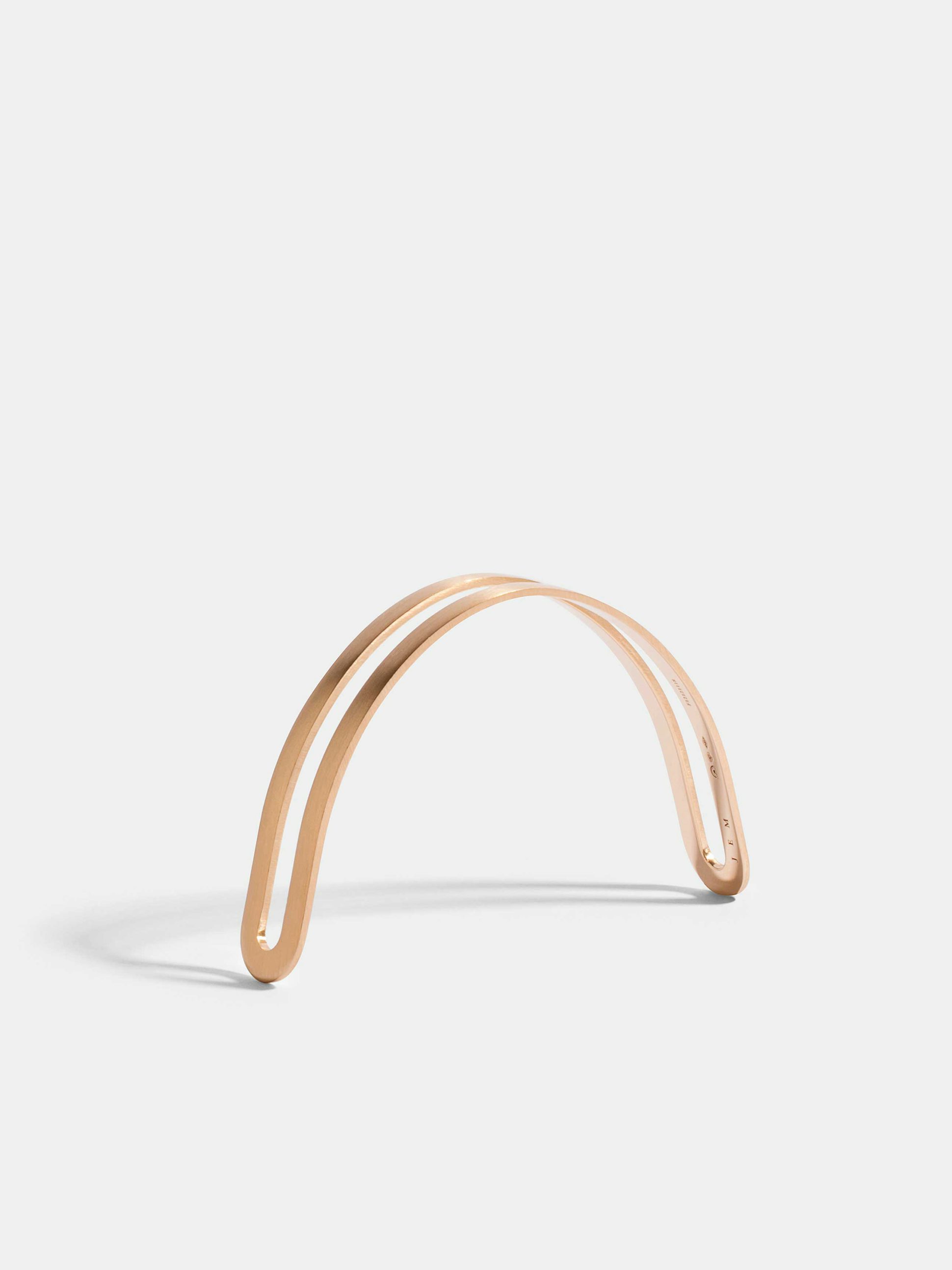 Étreintes simple half-bracelet in 18k Fairmined ethical rose gold with a brushed finish.