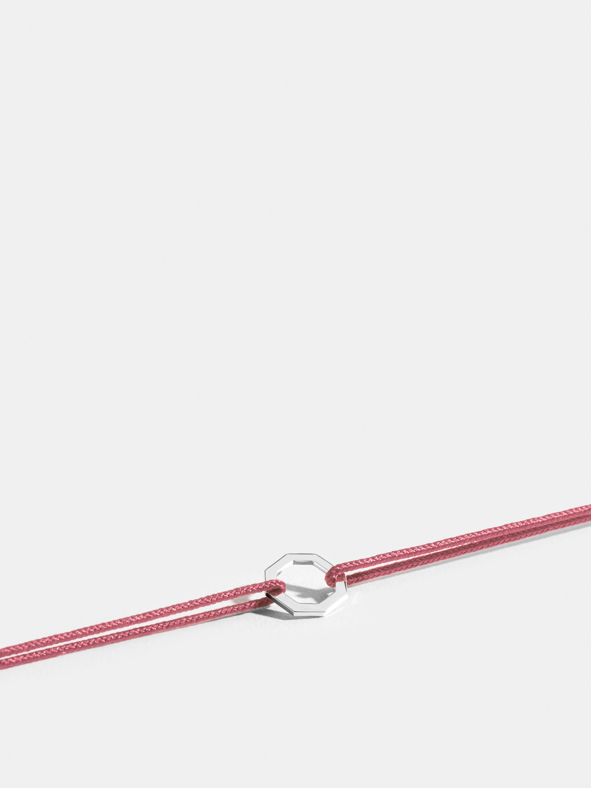Octogone motif in 18k Fairmined ethical white gold, on an antique pink cord. 
