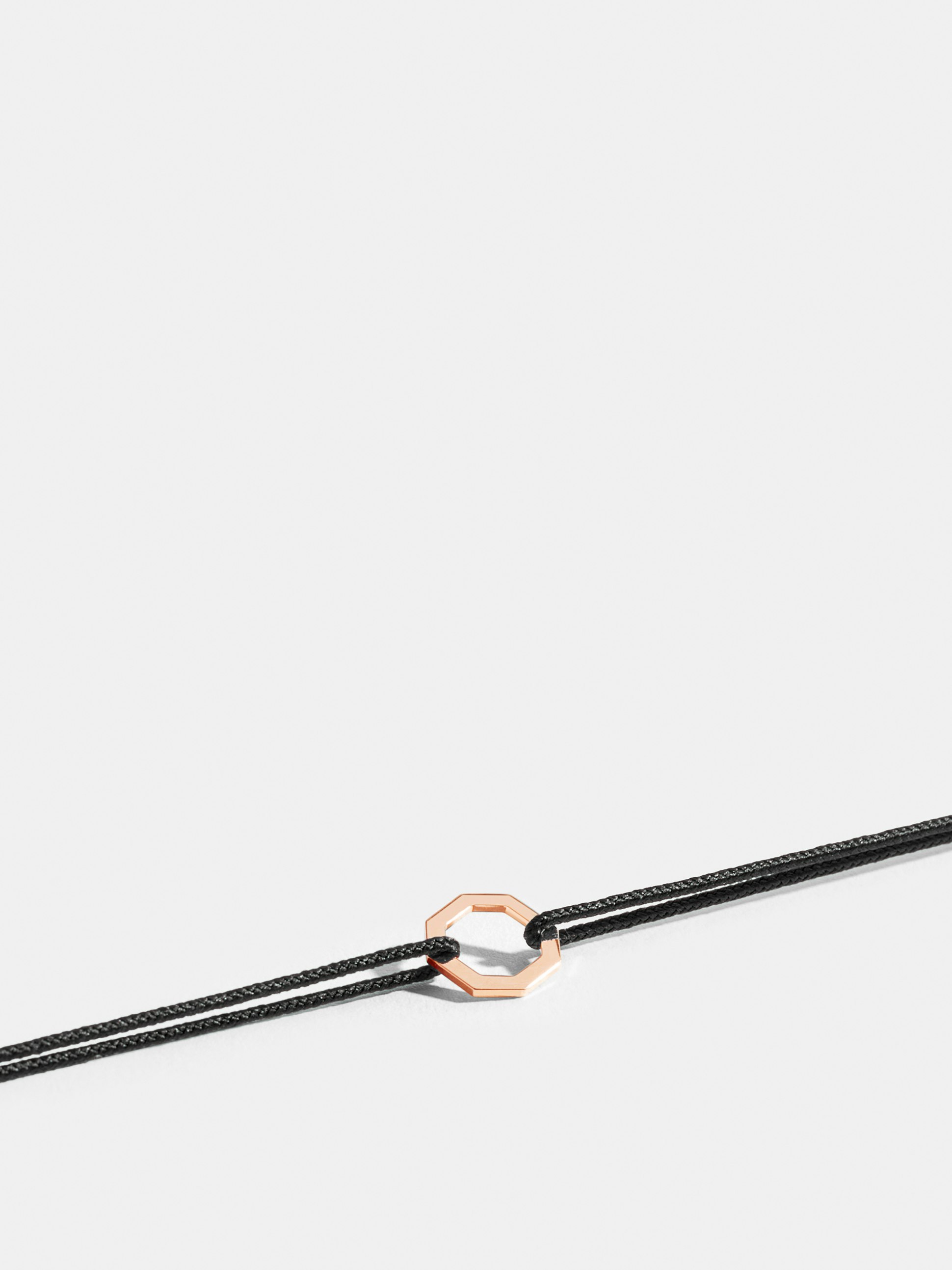 Octogone motif in 18k Fairmined ethical rose gold, on a black cord. 