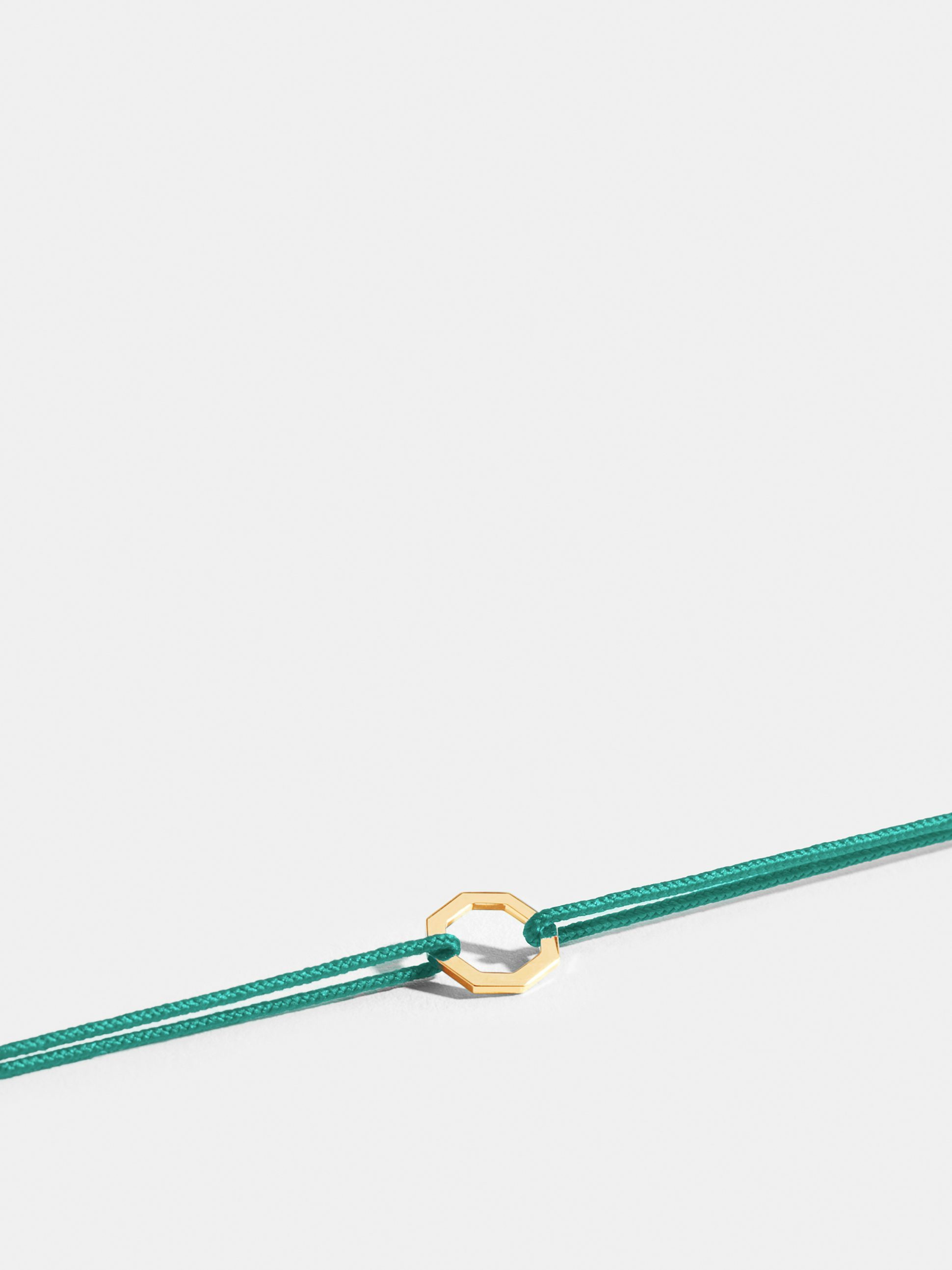 Octogone motif in 18k Fairmined ethical yellow gold, on a turquoise blue cord.