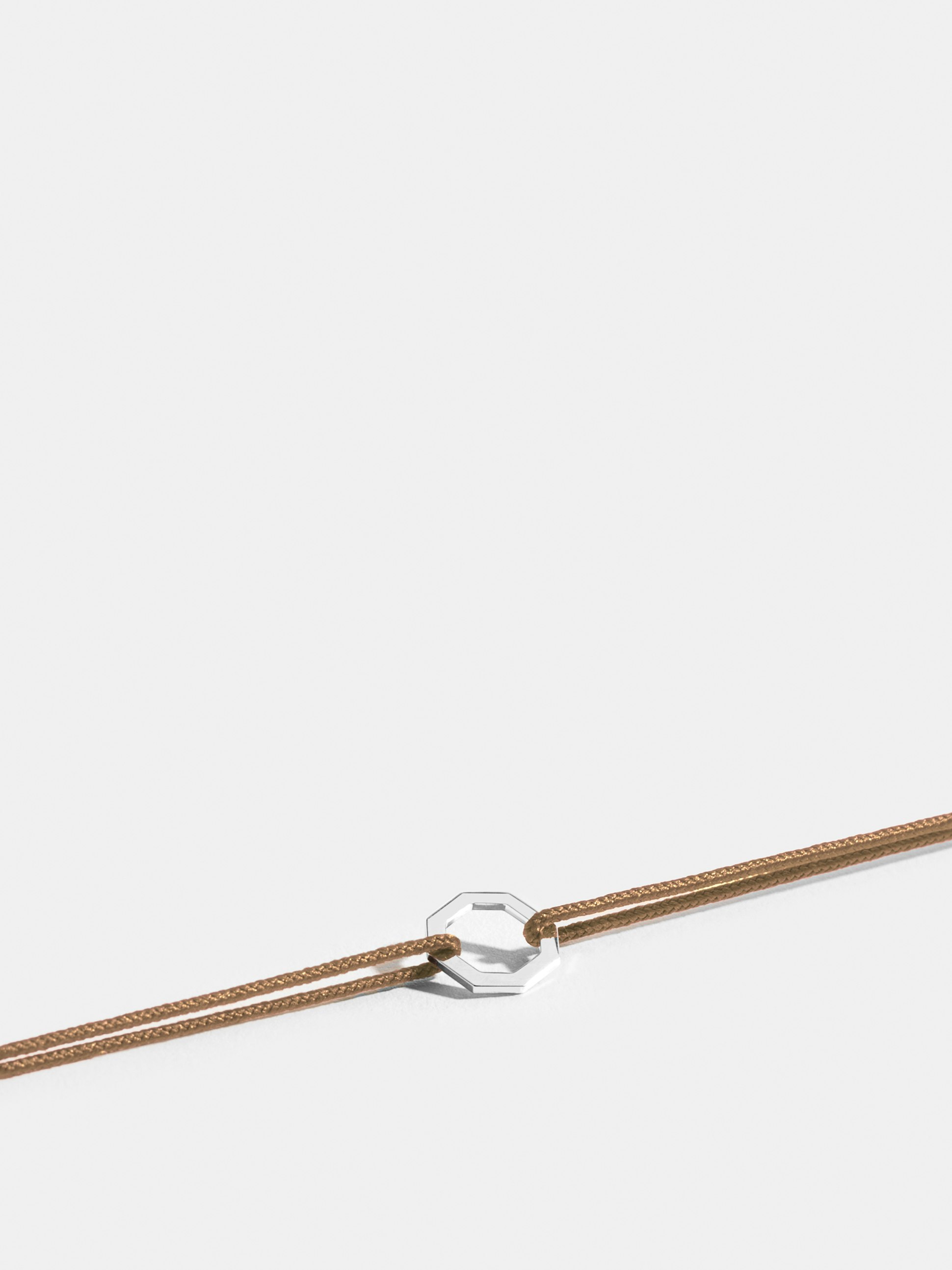 Octogone motif in 18k Fairmined ethical white gold, on a honey yellow cord. 
