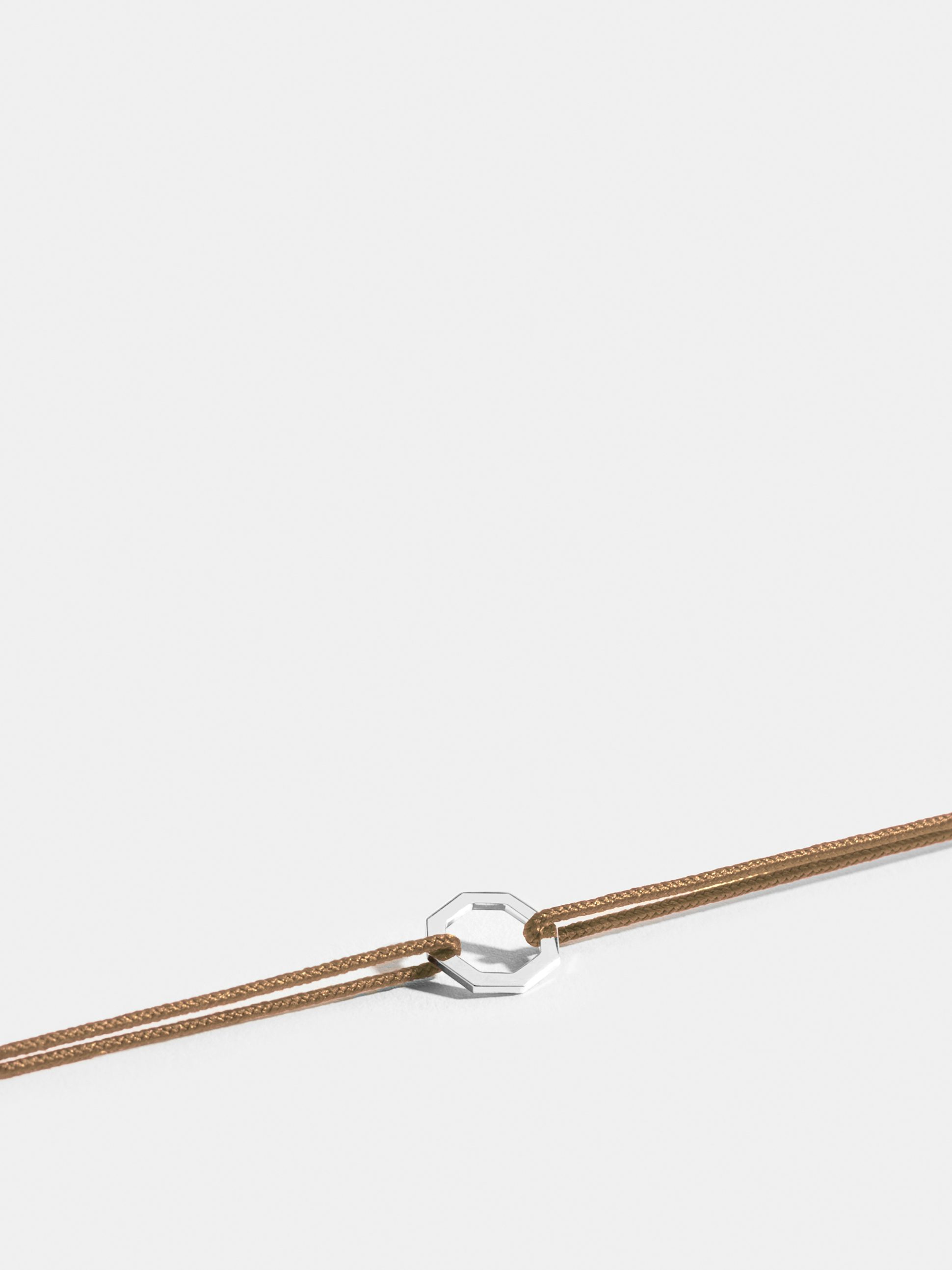 Octogone motif in 18k Fairmined ethical white gold, on a honey yellow cord. 