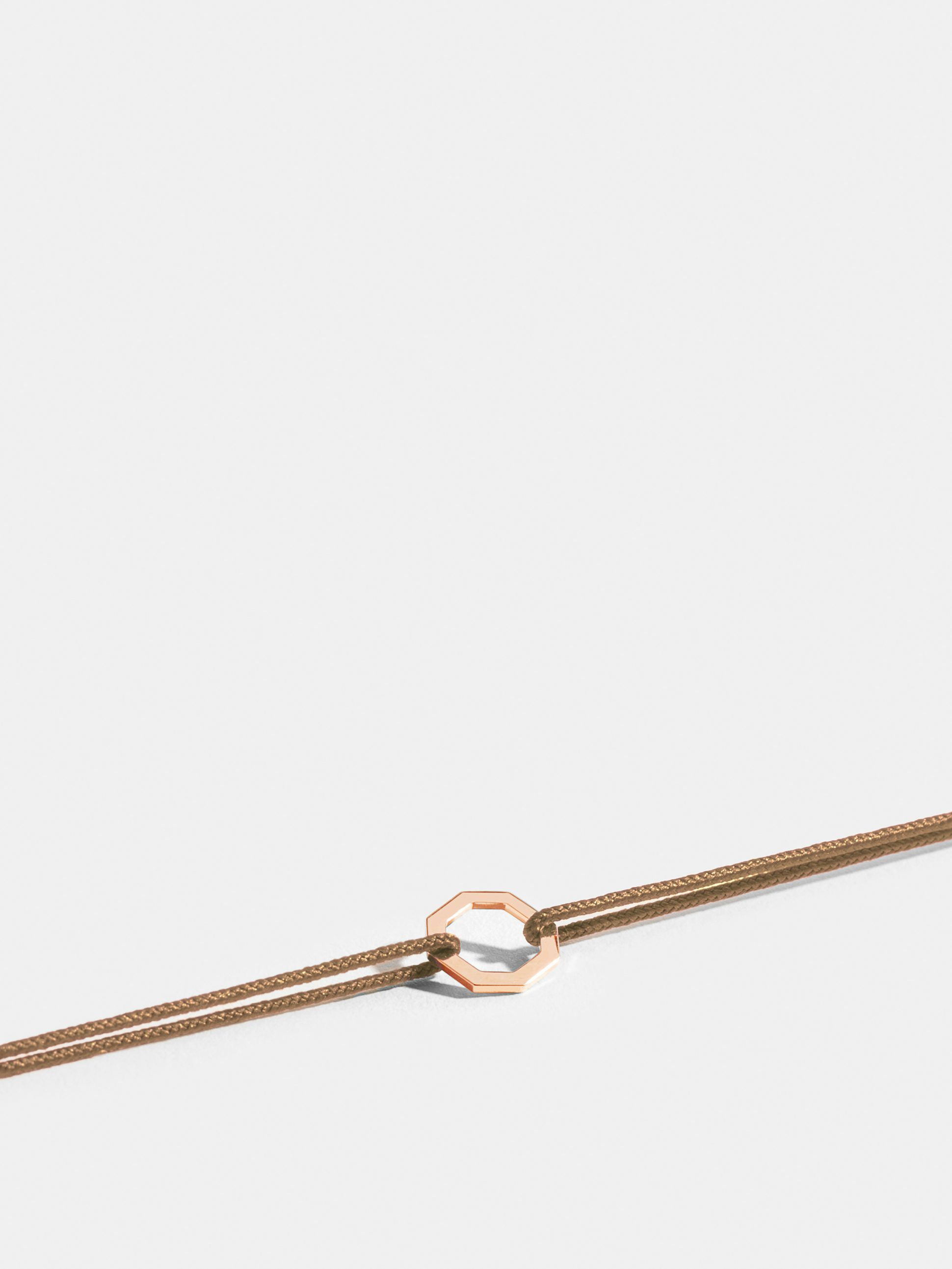 Octogone motif in 18k Fairmined ethical rose gold, on a honey yellow cord.