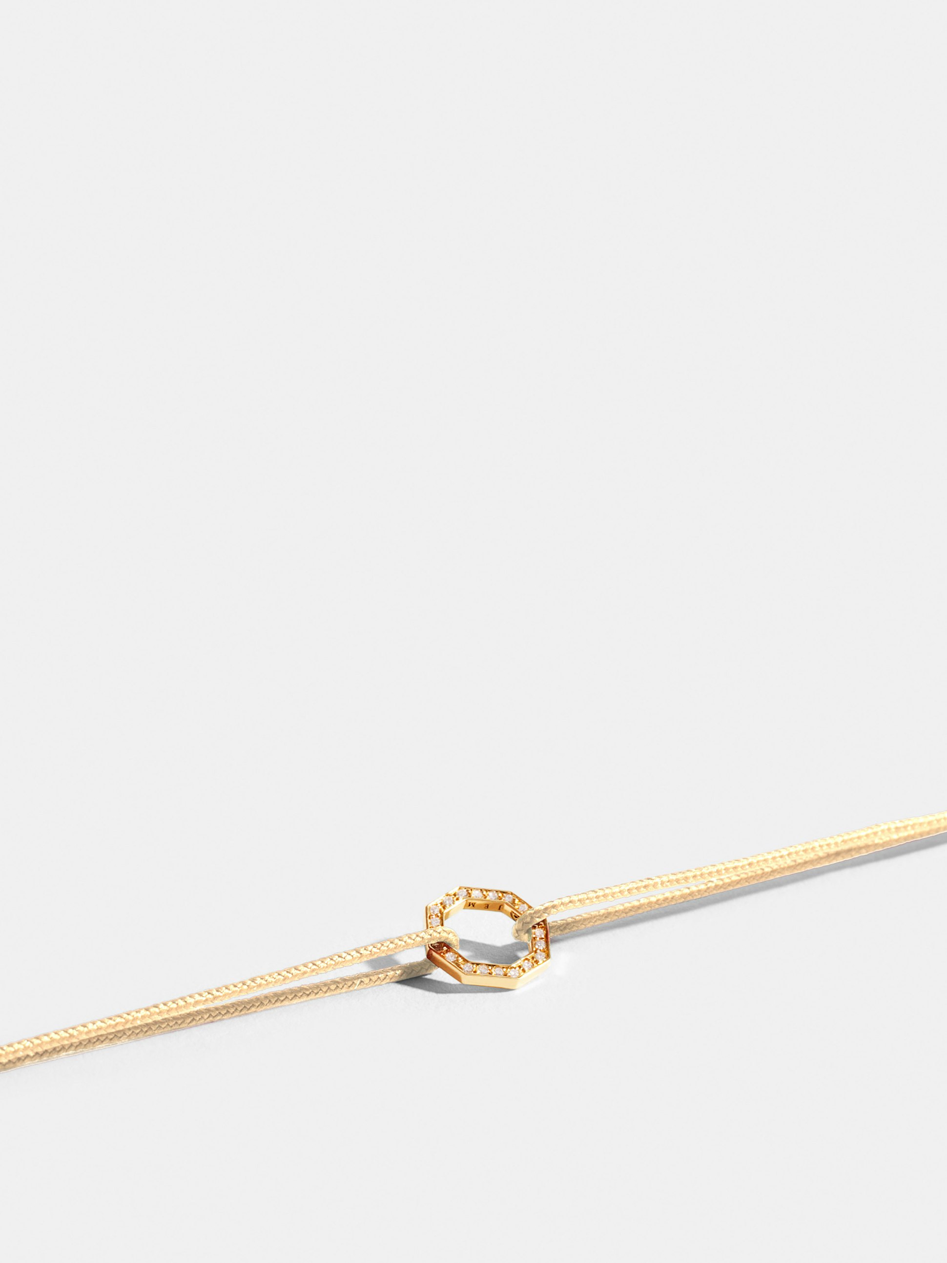 Octogone motif in 18k Fairmined ethical yellow gold, paved with lab-grown diamonds, on an antique ivory white.