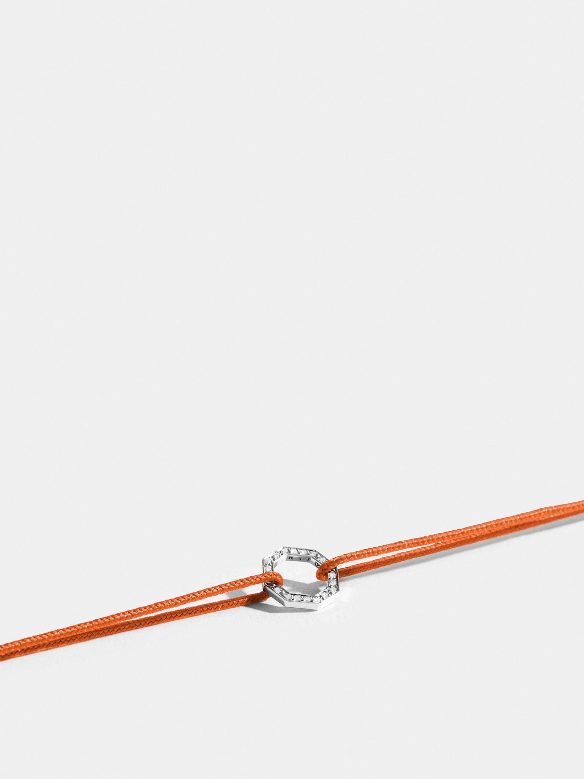 Octogone motif in 18k Fairmined ethical white gold, paved with lab-grown diamonds, on a bright orange cord.