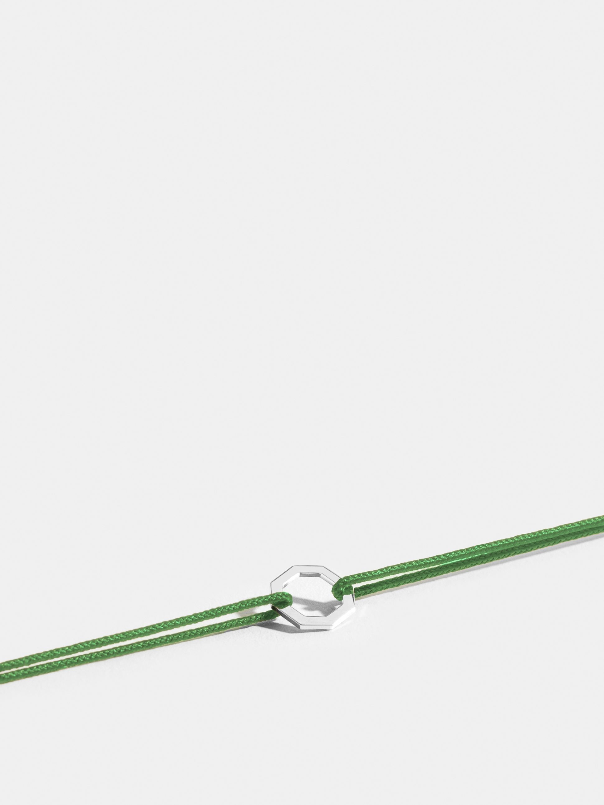 Octogone motif in 18k Fairmined ethical white gold, on an apple green cord. 