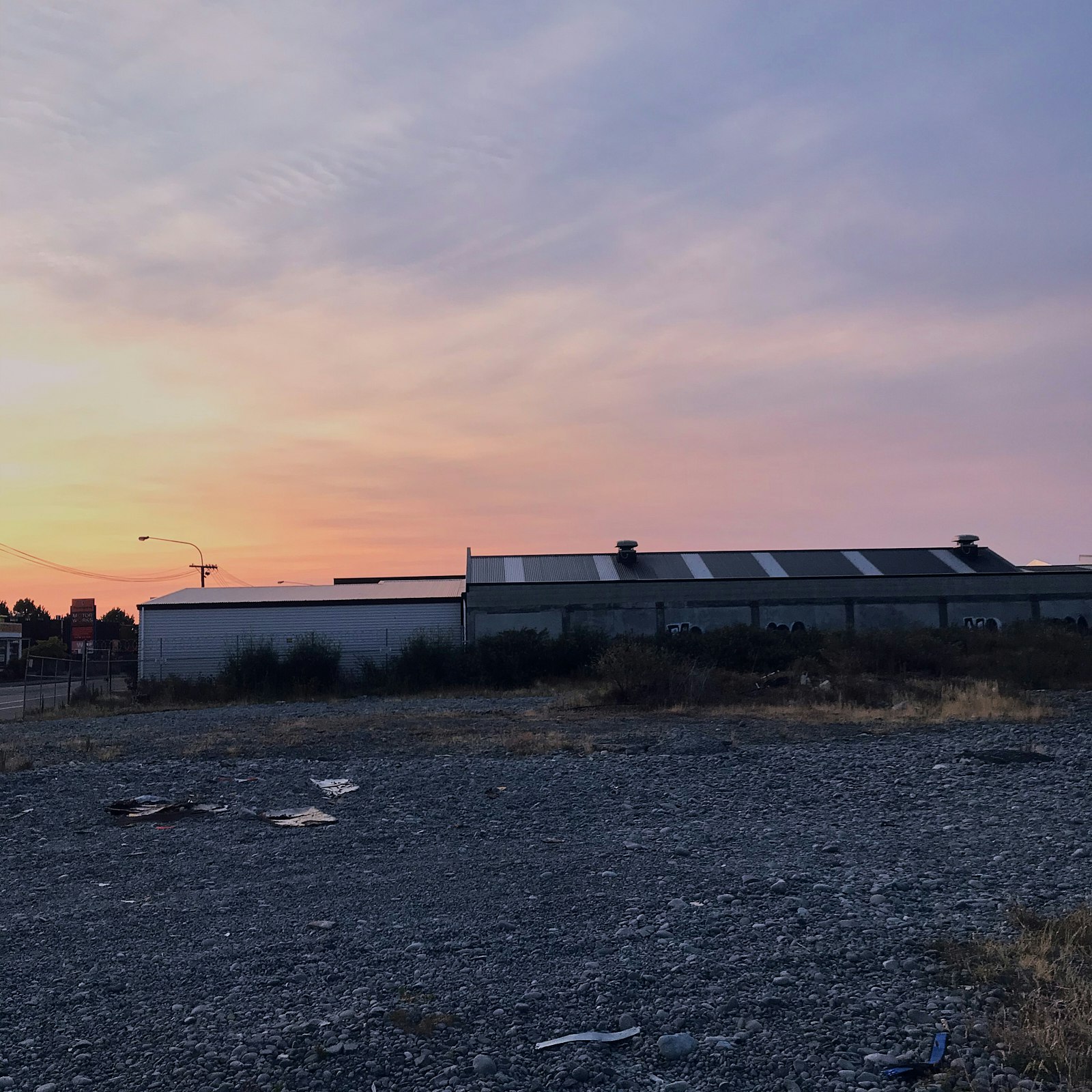 Sunset in a gravel lot.