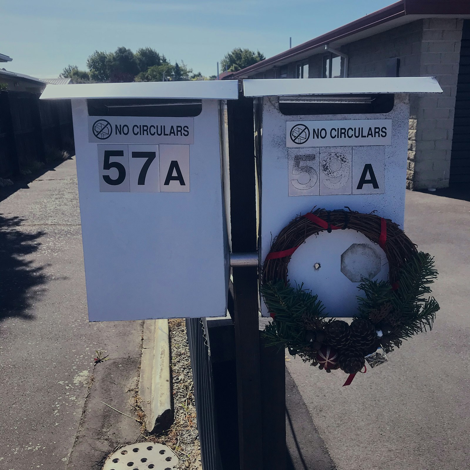 Two letterboxes, one with a wreath