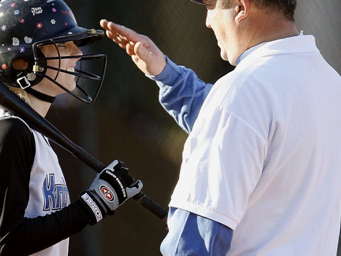 coach talking to a baseball player