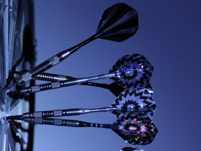 darts sticking out of a dart board