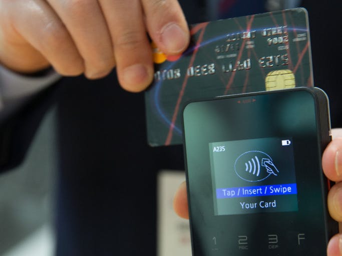 person swiping credit card