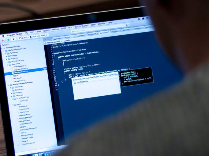 looking at laptop over a persons shoulder