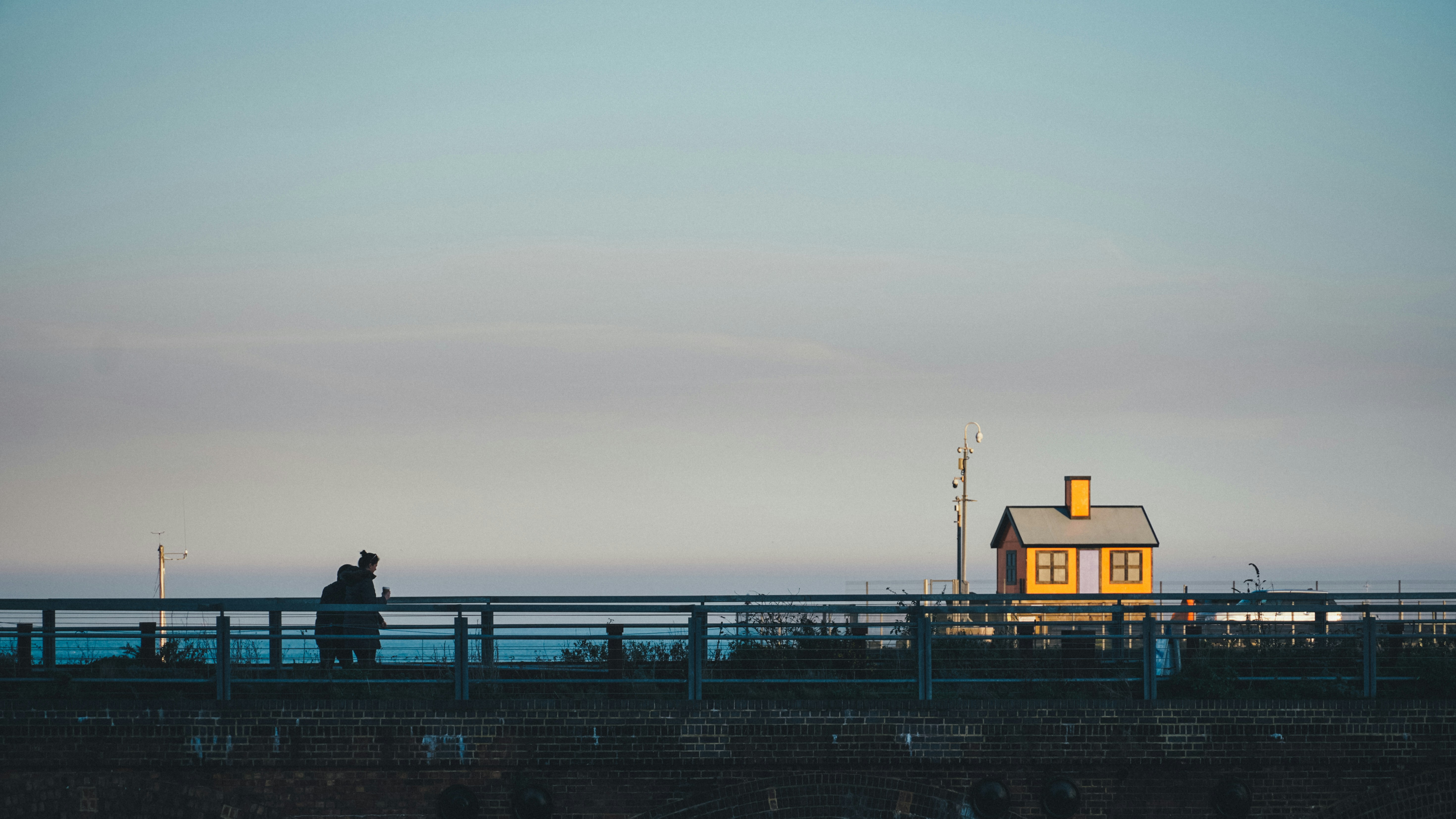 Small orange house on horizon behind bridge in Folkestone harbour