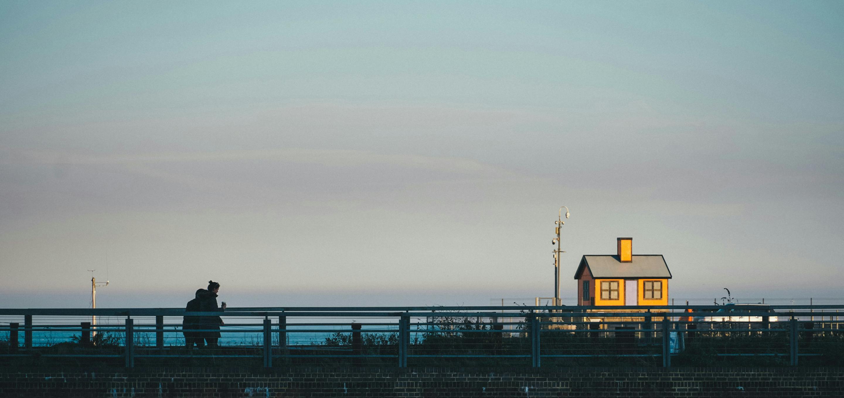 Small orange house on horizon behind bridge in Folkestone harbour