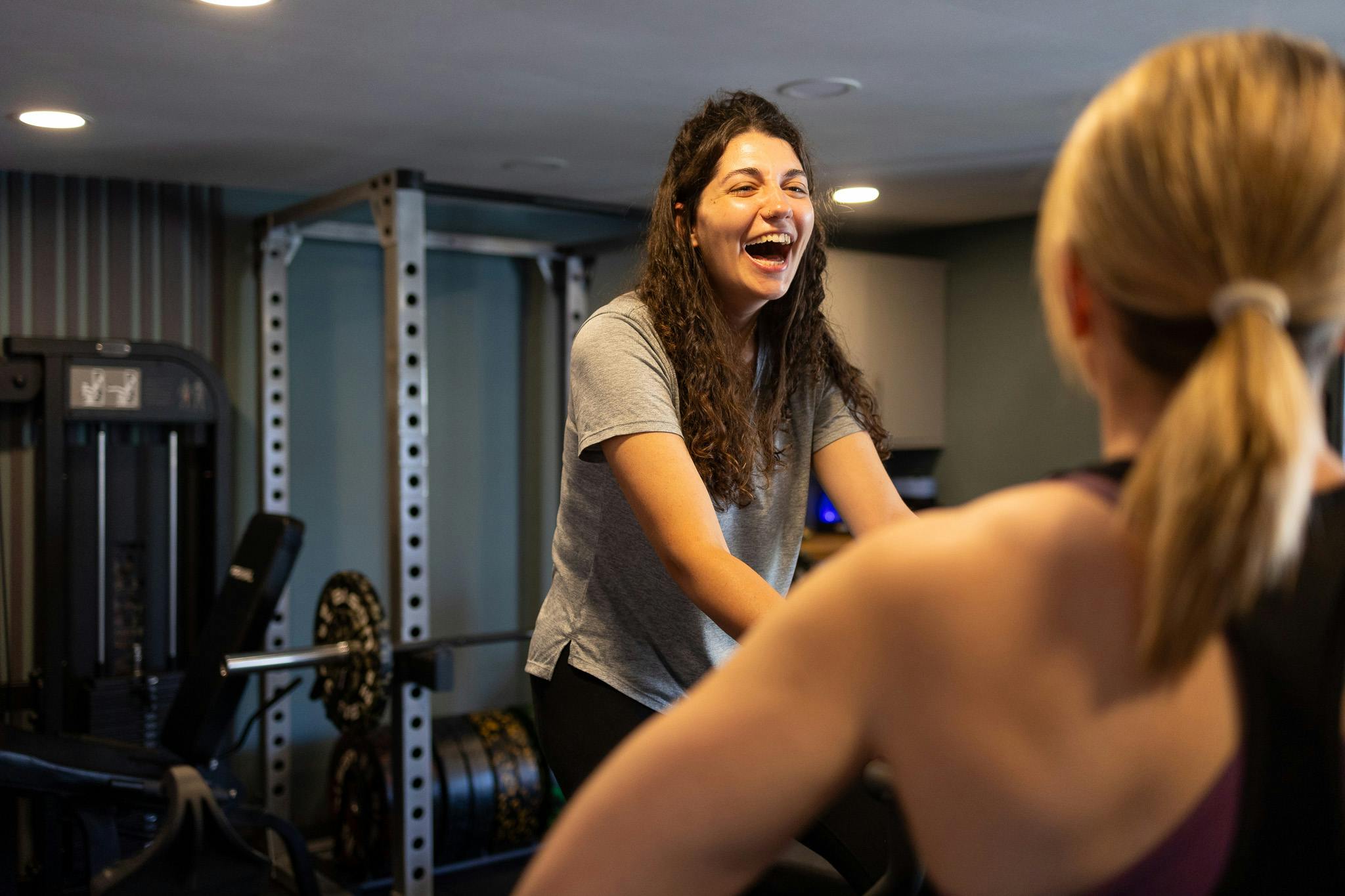 PT talking to a client on exercise bike in Jess-fit studio