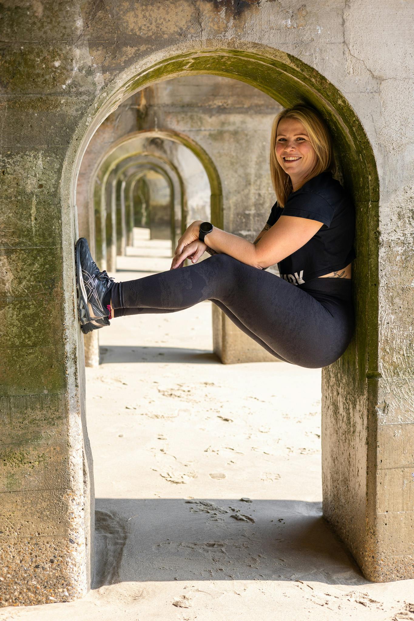 Jess from Jess-Fit balancing in the arches in Folkestone Harbour