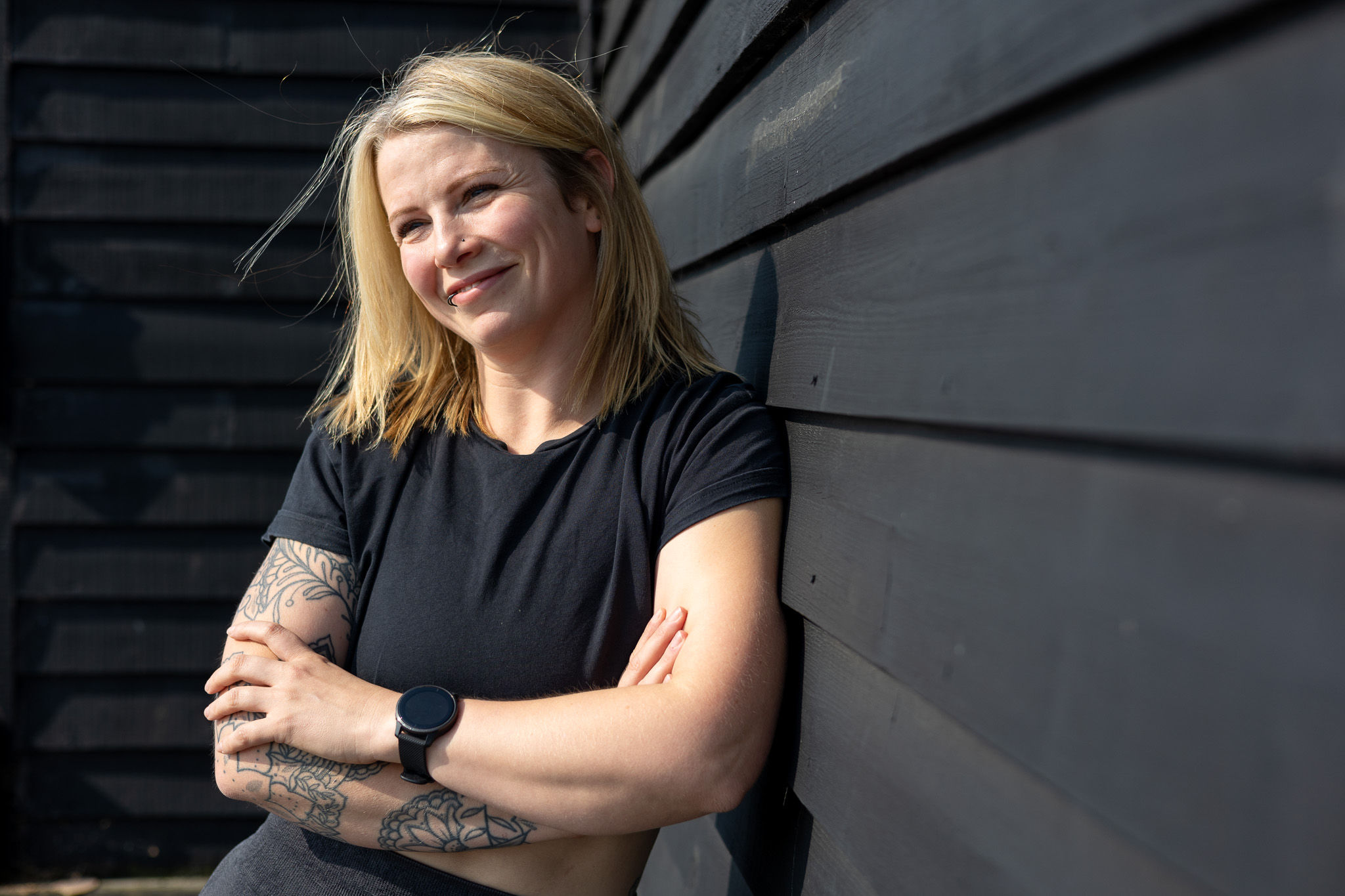 Jess from Jess-Fit standing next to shiplap wall in Folkestone Harbour