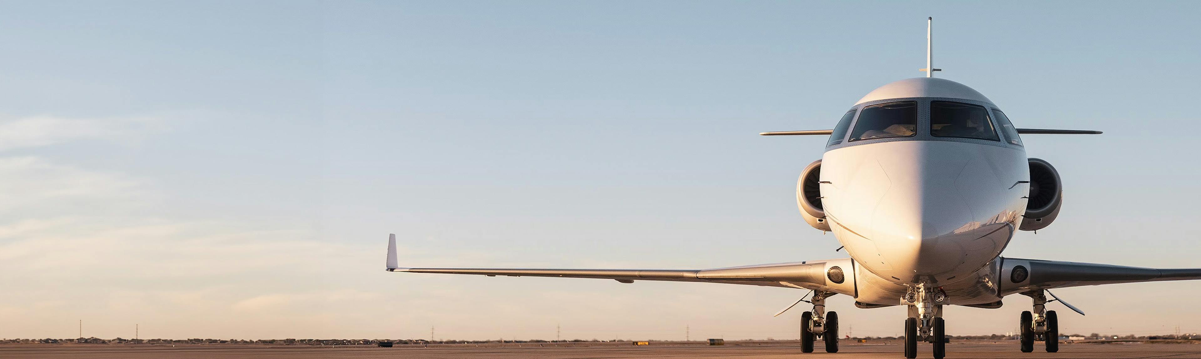 A photo of a private jet at dusk