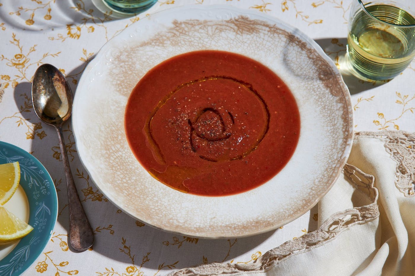Gazpacho with a drizzle of olive oil and freshly cracked pepper, with a side of white wine and lemons.