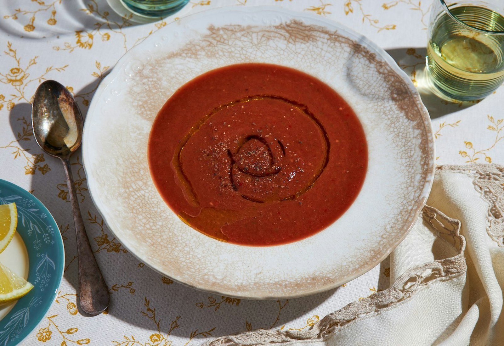 Gazpacho with a drizzle of olive oil and freshly cracked pepper, with a side of white wine and lemons.