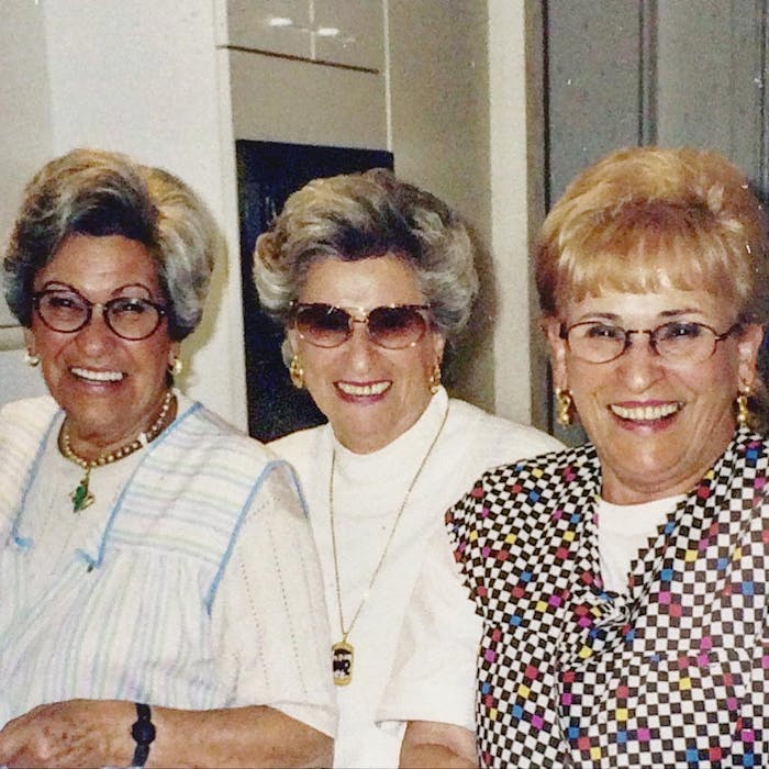 Becca's grandmother Mala (right) in the 90s, laughing with her two sisters. 