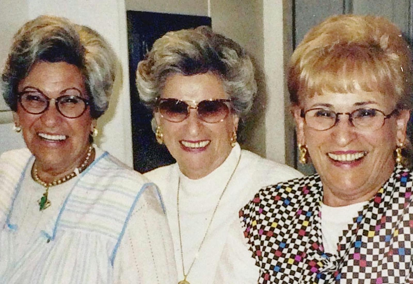 Becca's grandmother Mala (right) in the 90s, laughing with her two sisters.