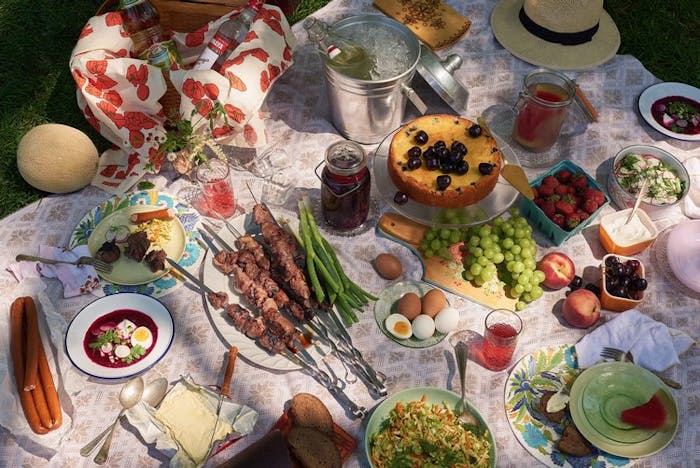Russian picnic spread atop picnic blanket.