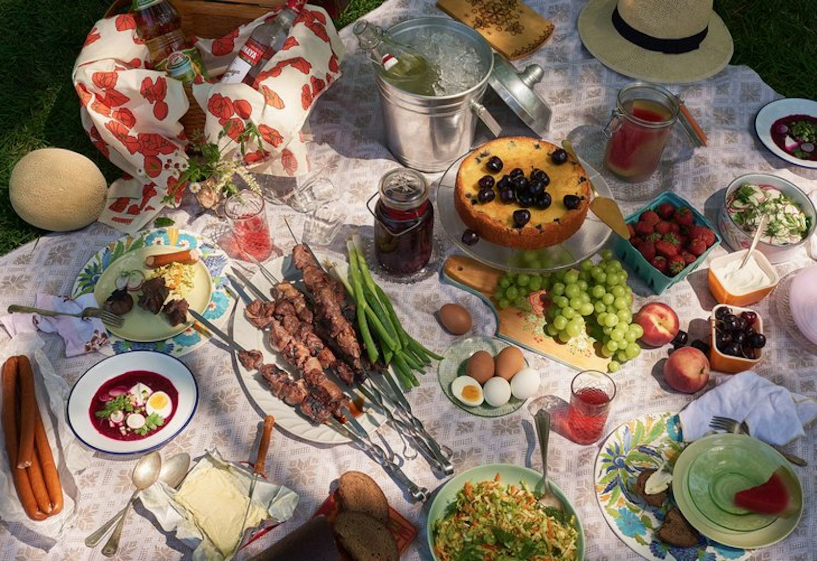 Russian picnic spread atop picnic blanket.