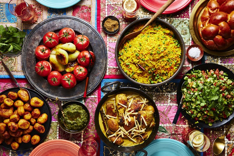 Vibrant shabbat table with spread of Indian-Baghdadi Jewish dishes.