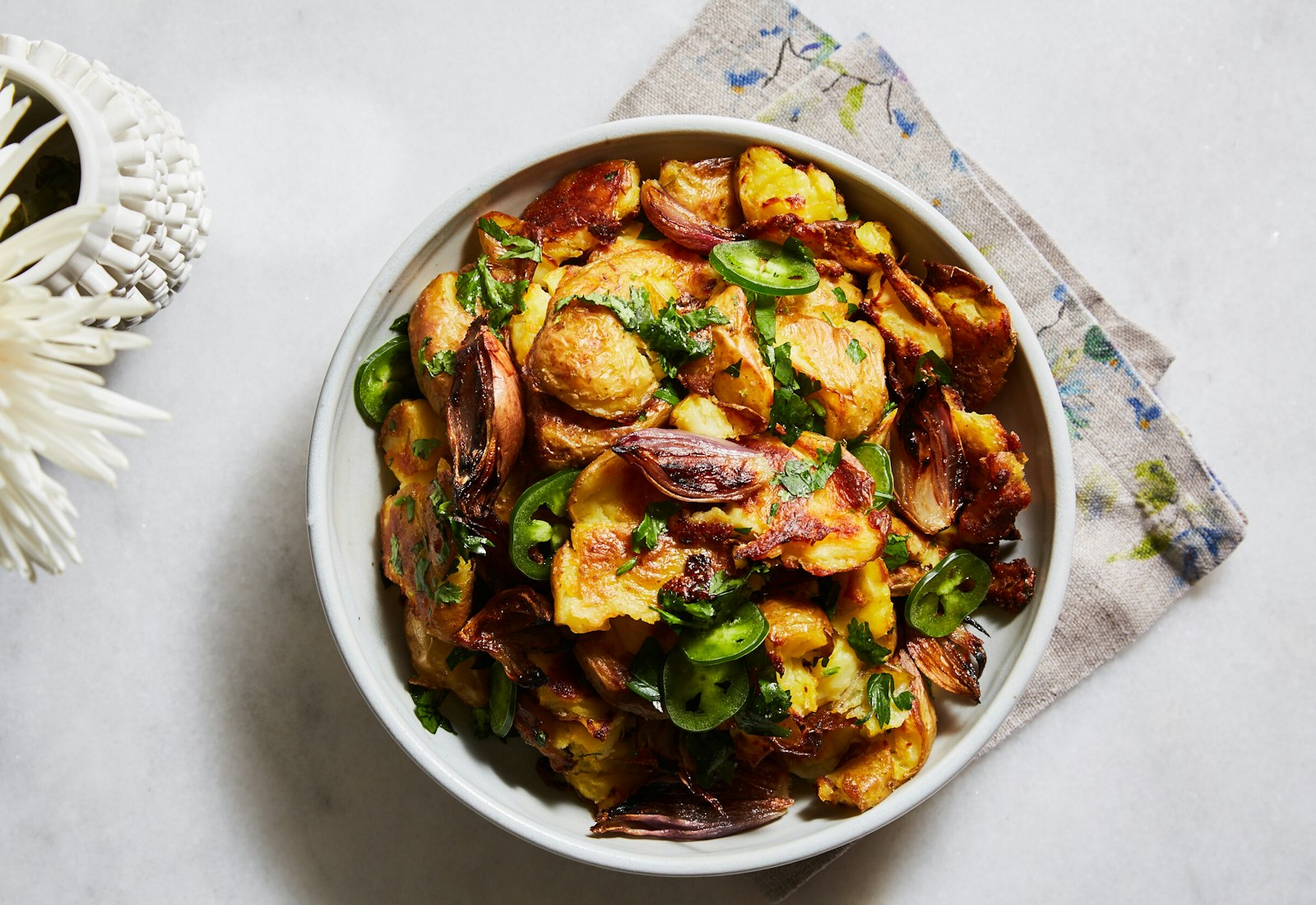 Crispy smashed potatoes in white bowl