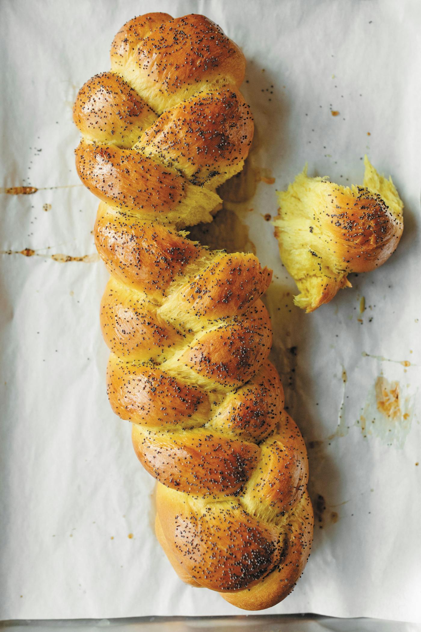 Braided challah on lined sheet pan.