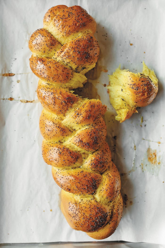 Braided challah on lined sheet pan.