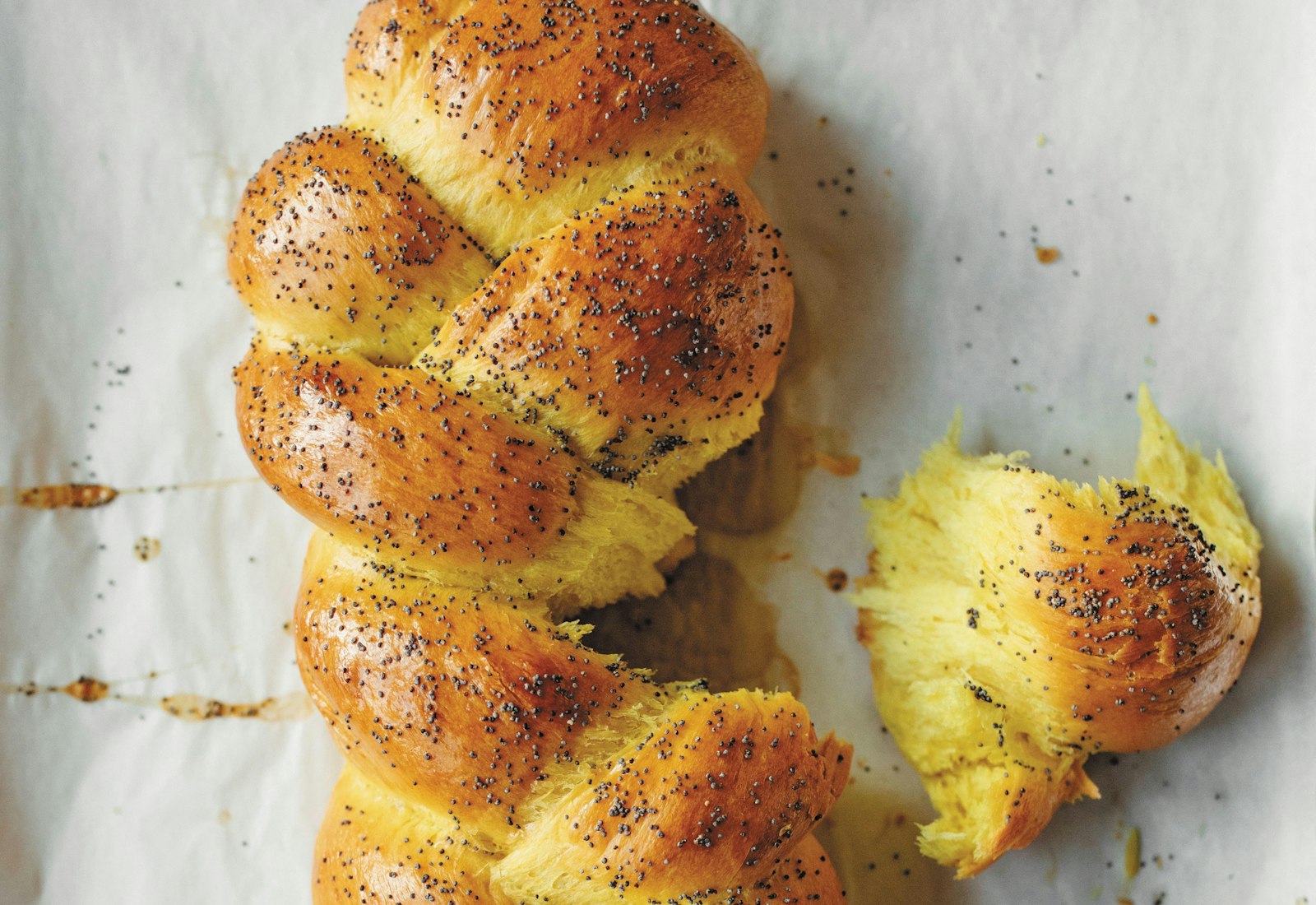 Braided challah on lined sheet pan.