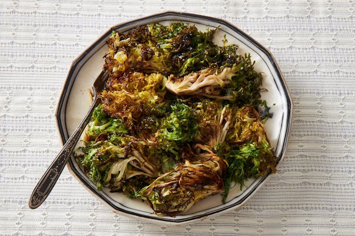 Toasted frisée on black and white plate.