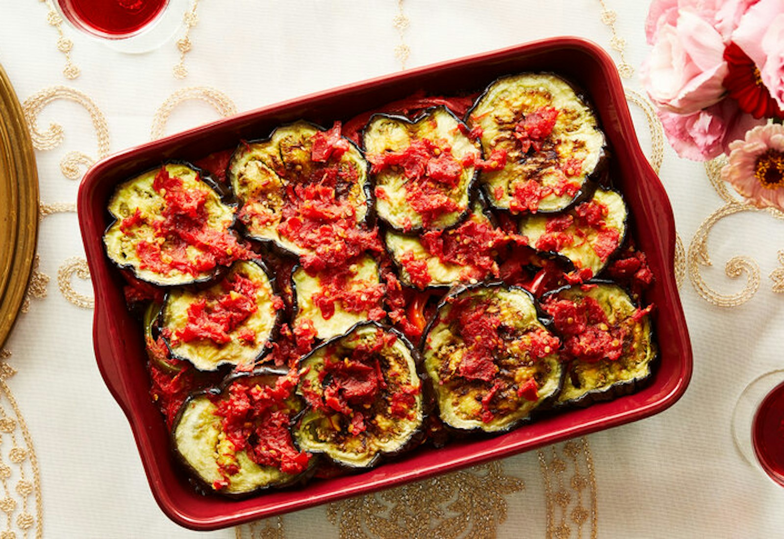 Ingriye in red roasting pan, pink flowers and red wine.