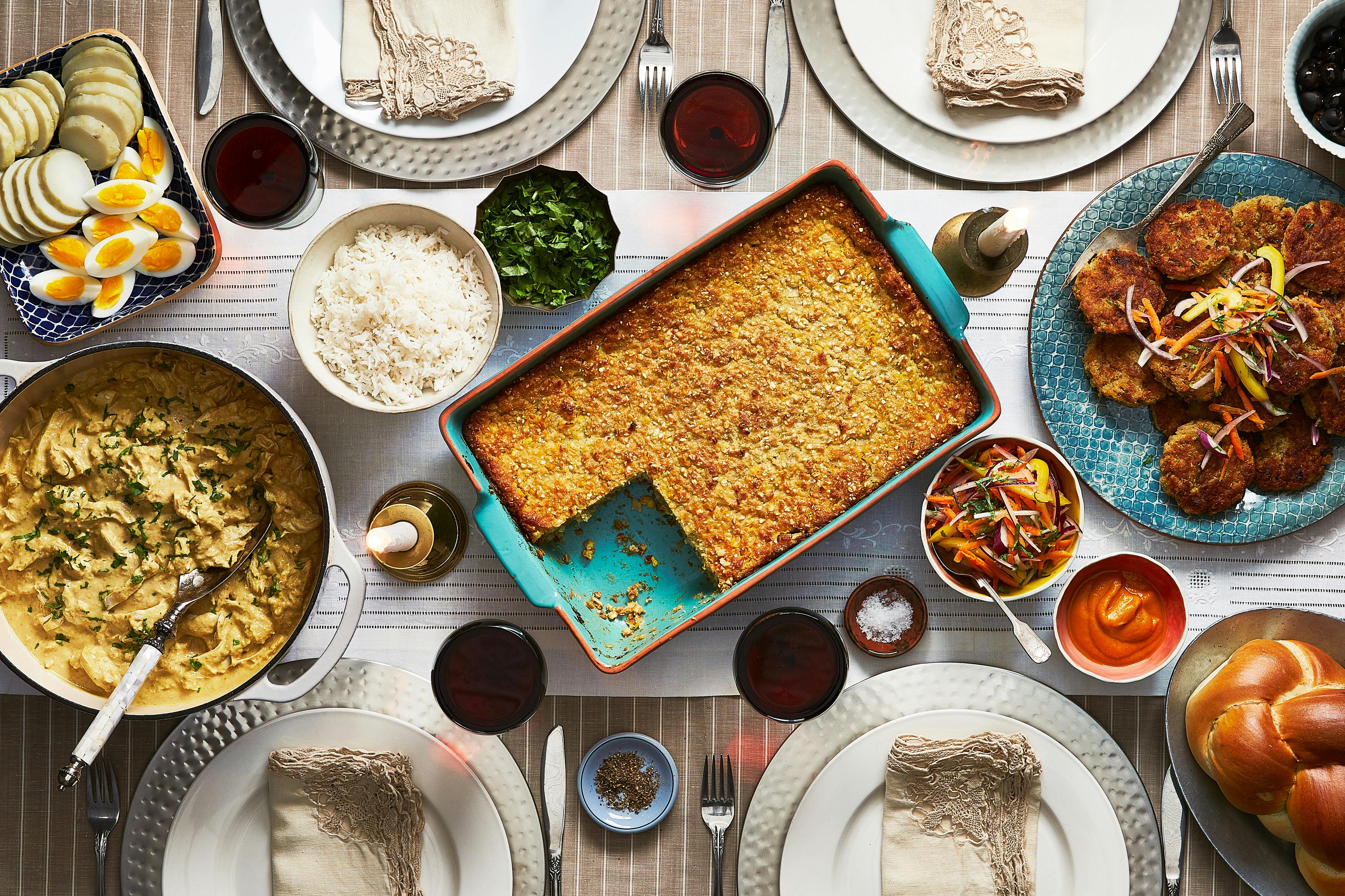 Ají de Gallina, Pastel de Choclo and Tacu-Tacu on a Shabbat dinner table spread.