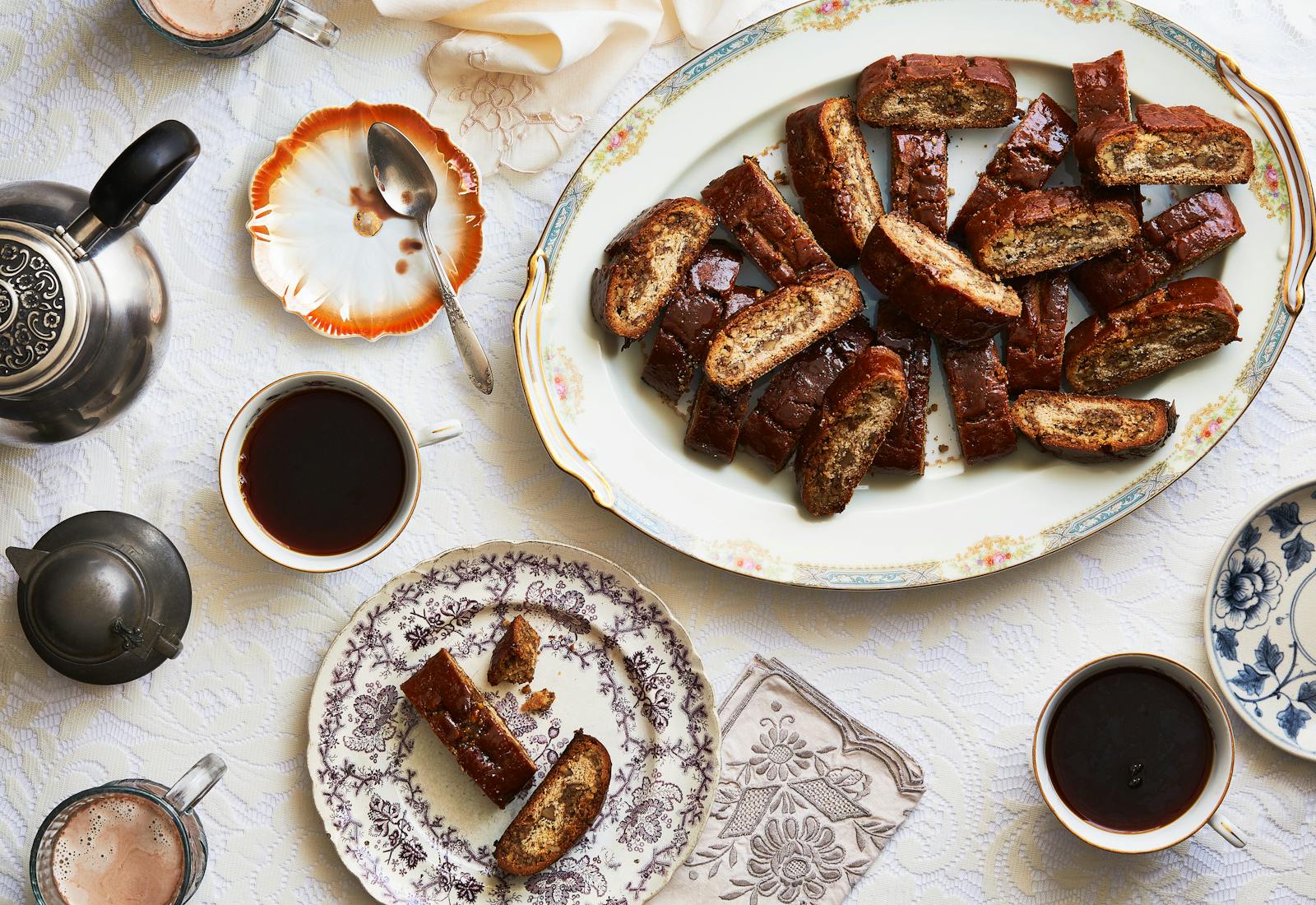 Kindle on serving platter alongside cups of tea.