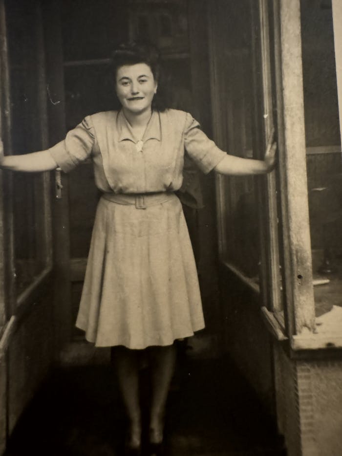 Donna's mother, Magdalena standing outside a storefront. 